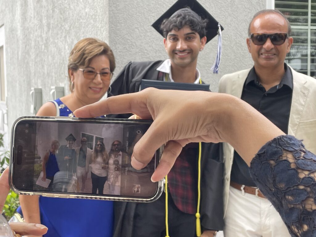 A photo being taken of a graduate and their family