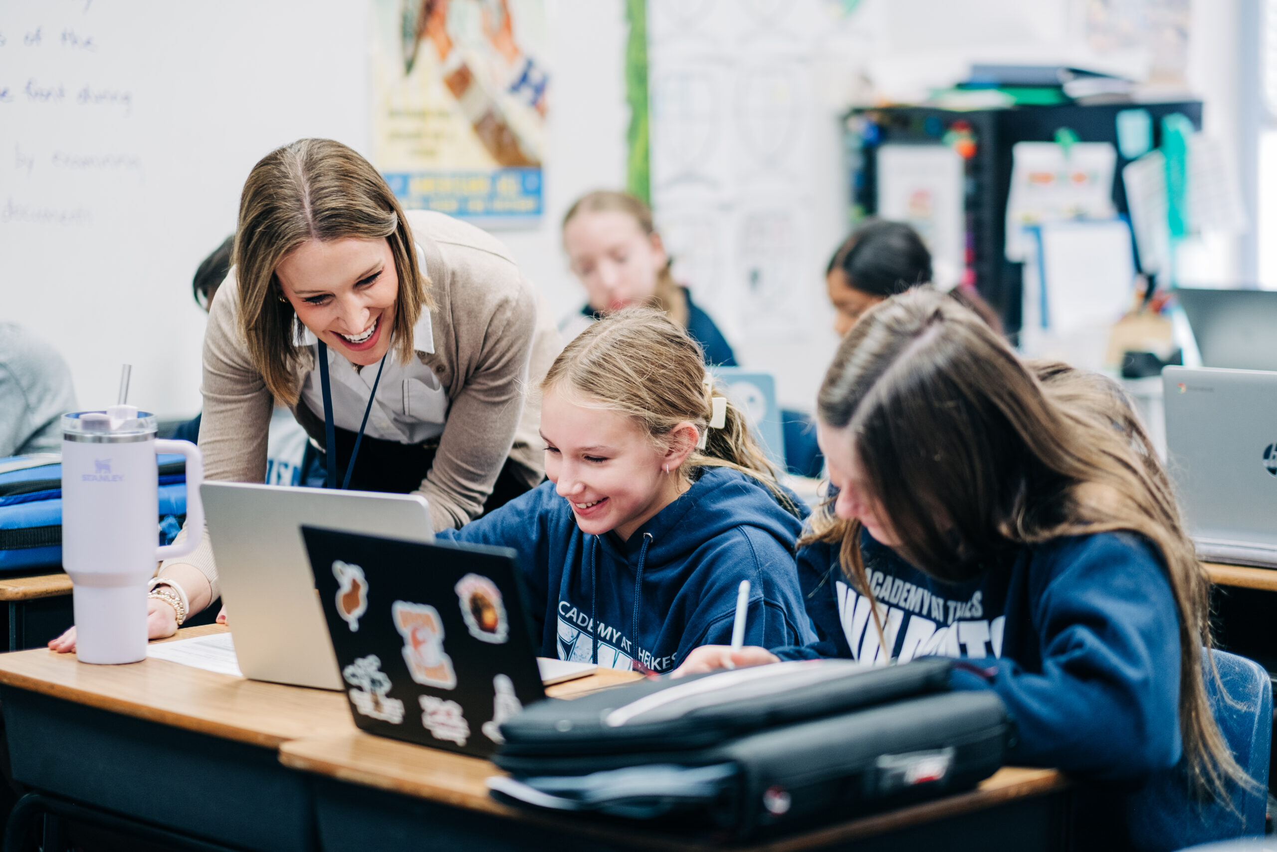 Joyful teacher interacting with students